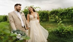 Wedding couple laughing in vineyard