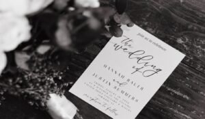 Wedding detail photo of invitation with wood background