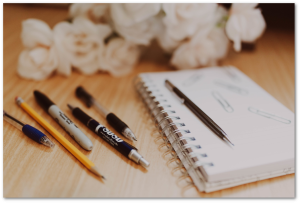 Notebook with pencils and pens