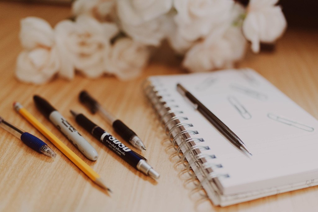Notebook with pencils and pens