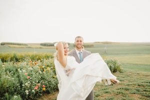 Groom carrying bride
