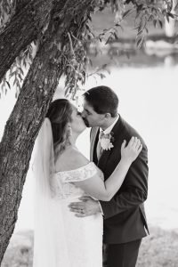 Wedding couple kissing under a tree