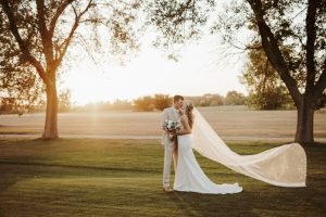 Wedding couple kissing on a golf course