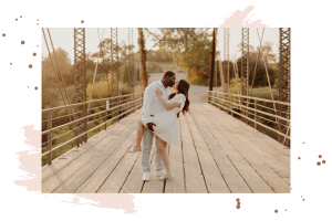 Engaged couple kissing on a bridge