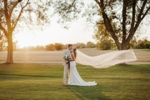Wedding couple kissing on a golf course