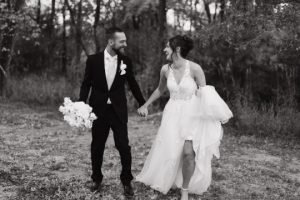 Wedding couple running towards camera laughing