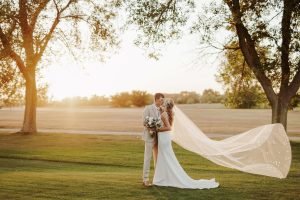 Wedding couple kissing on a golf course