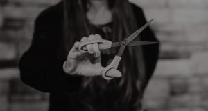 Branding portrait of a women holding scissors