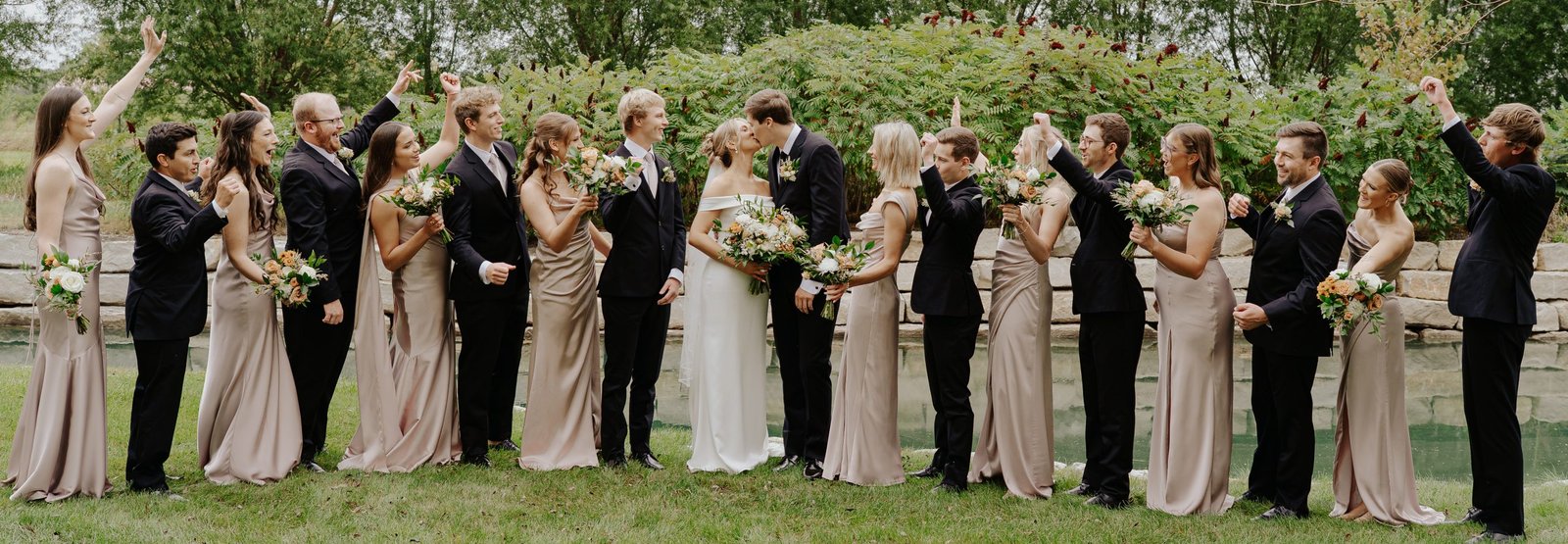 Wedding couple and wedding party cheering