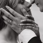 Wedding couple holding hands about to kiss