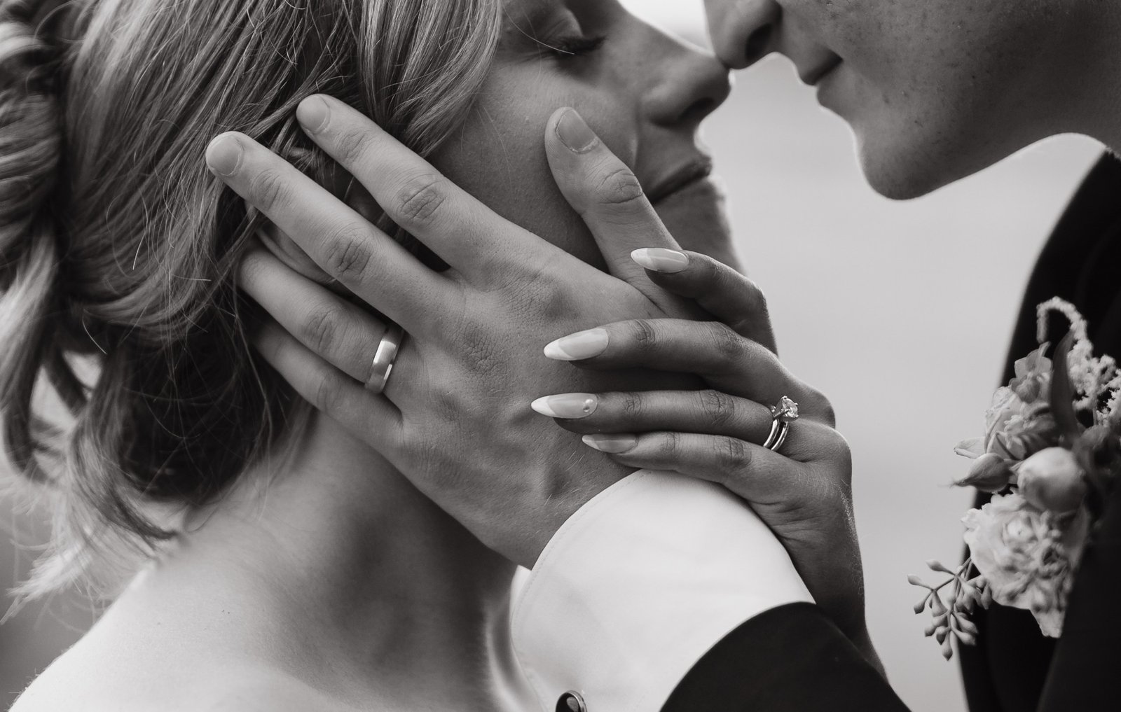 Wedding couple holding hands about to kiss