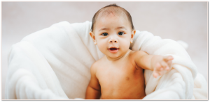 Milestone session of a baby sitting in a basket