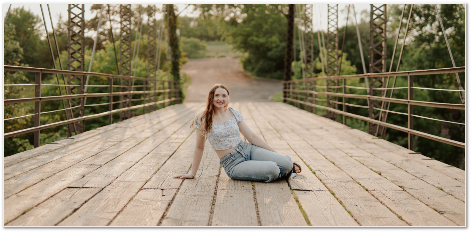 Senior session girl sitting on a bridge