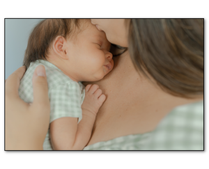 Newborn baby being held by mom