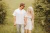 Engagement couple walking in fields