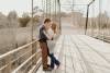 Engaged couple on bridge about to kiss